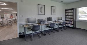 row of computers and bookshelf