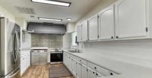 kitchen area with cabinets, fridge, oven, stove